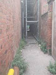 A brick walkway with pipes

AI-generated content may be incorrect.