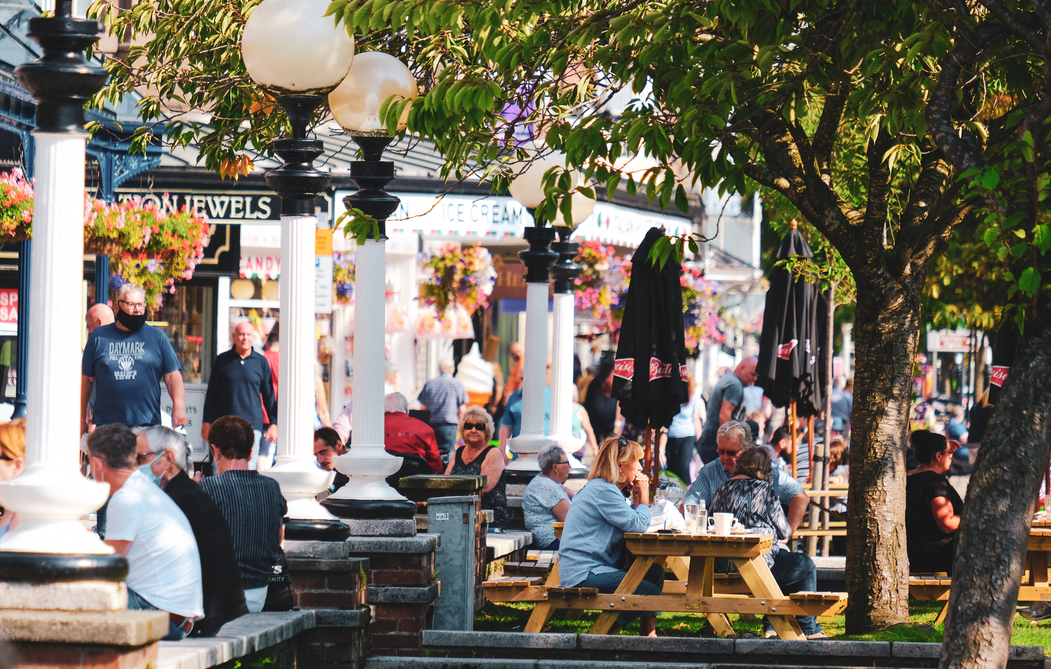 Image of Lord Street with people sitting outside a bar