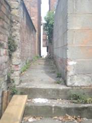 A brick walkway with a brick wall

AI-generated content may be incorrect.